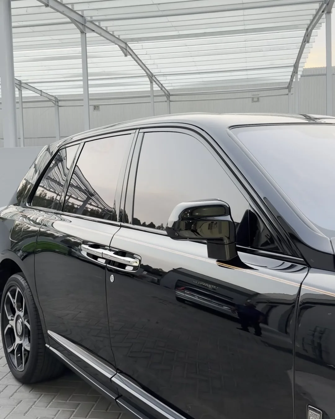 Rolls-Royce Cullinan with tinted windows, at the customer's building