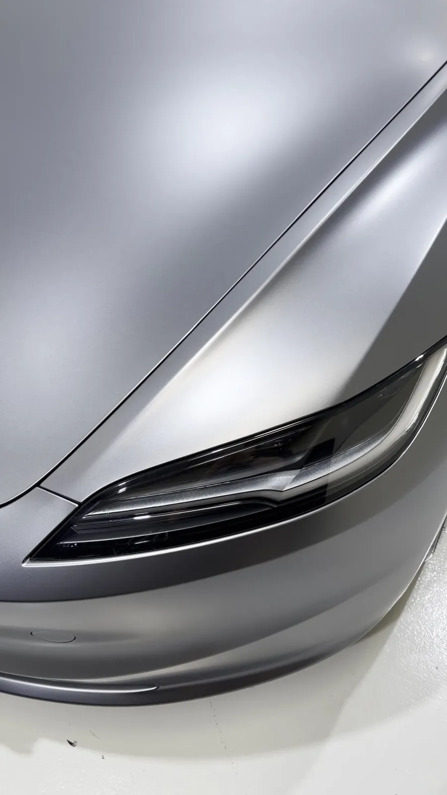 Tesla headlight and bonnet edge under matte PPF